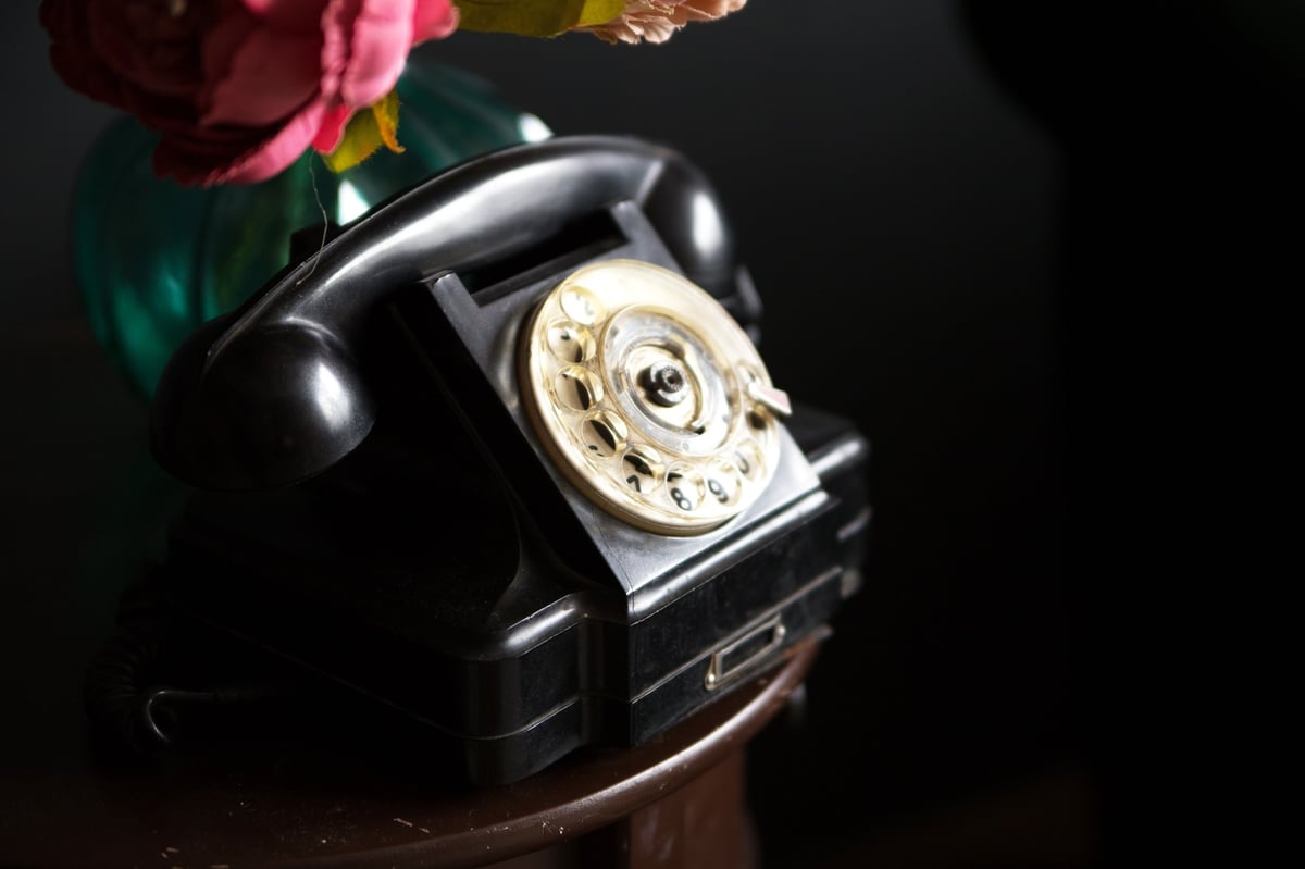 Vintage rotary phone with decorative flowers